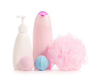 bottle of shampoos, bath bombs, and a loofah